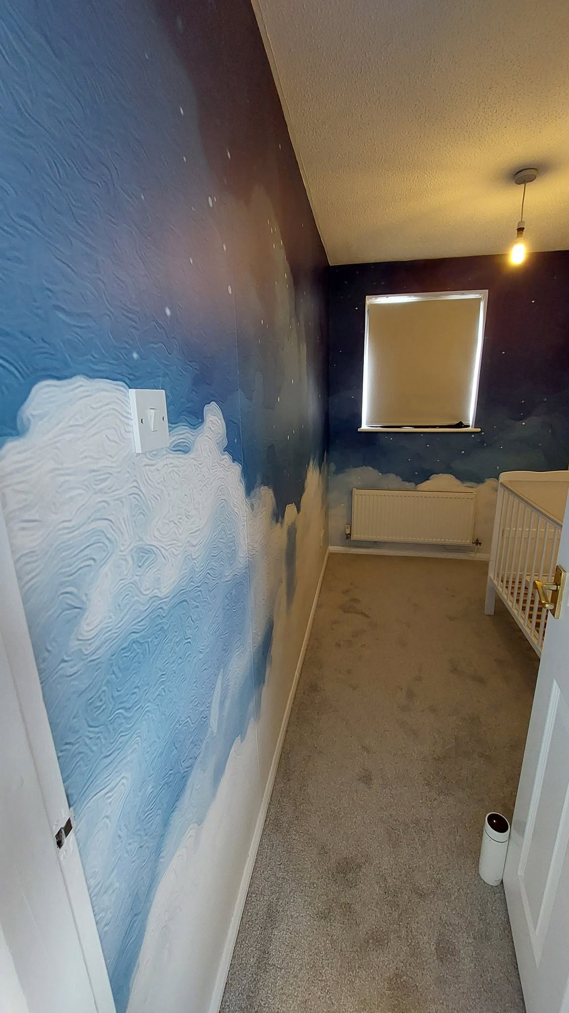 Child's bedroom with sky and cloud mural wallpaper