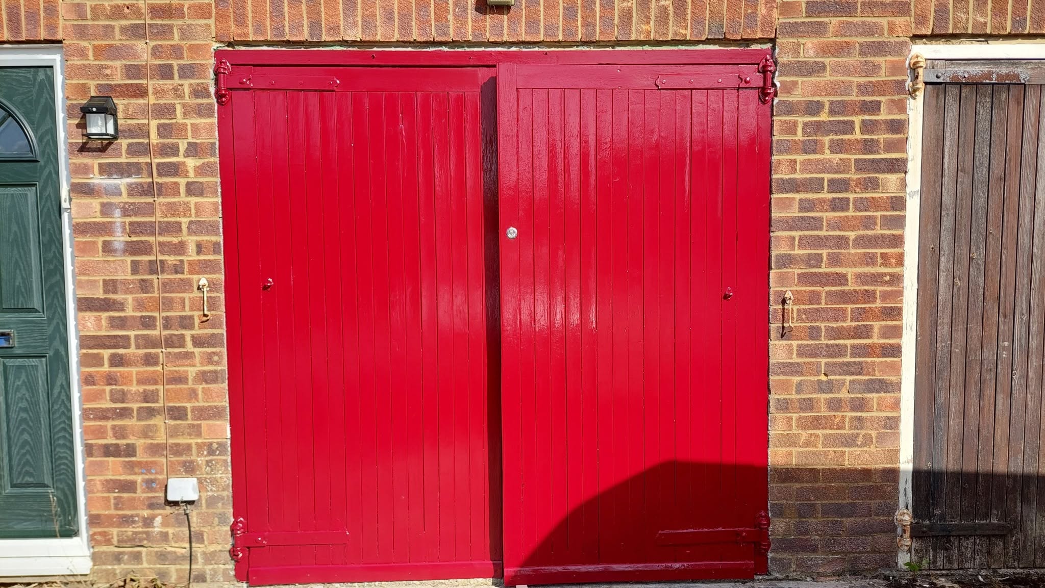 Pair of timber outbuilding doors painted gloss red