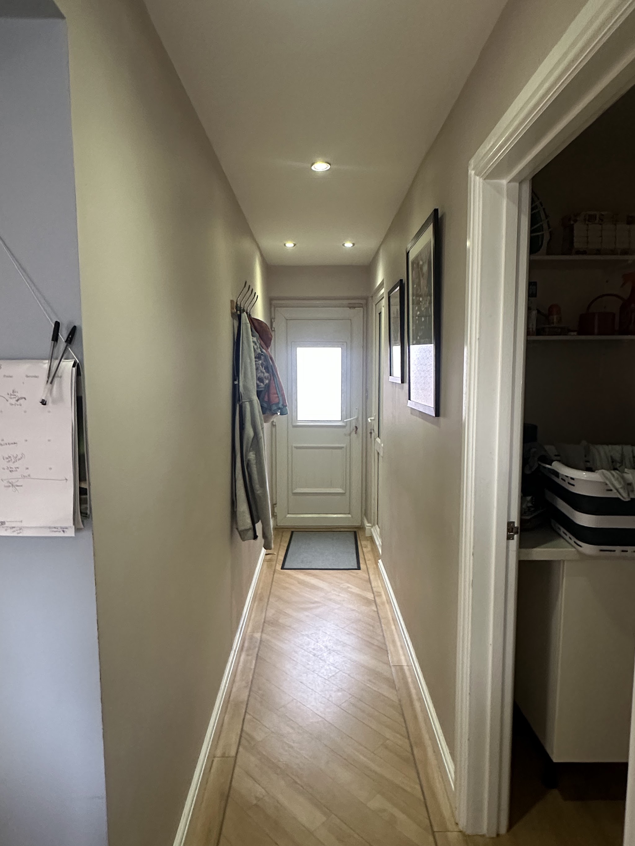 Long hallway finished in grey with a light wood floor
