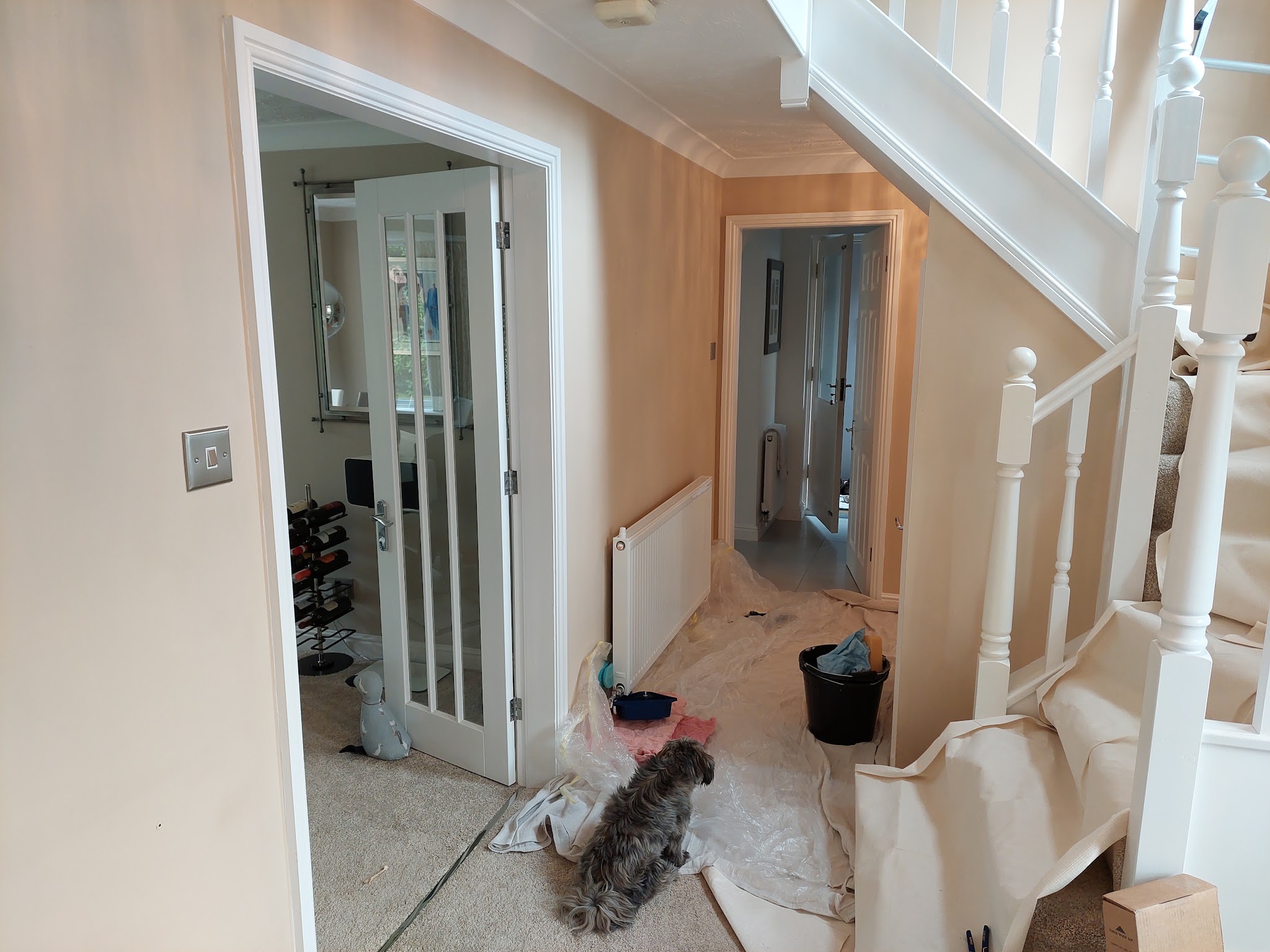 Hall and stairs mid-job with dust sheets down